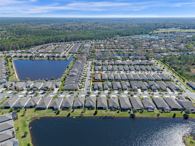 drone / aerial view with a water view and a residential view