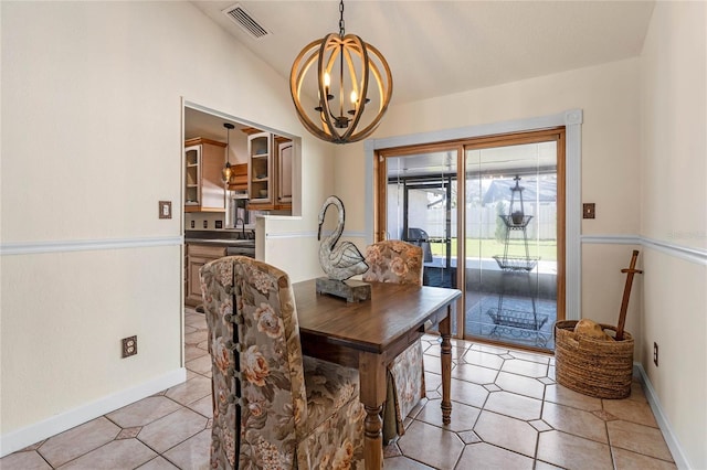 dining room with vaulted ceiling, visible vents, a notable chandelier, and baseboards