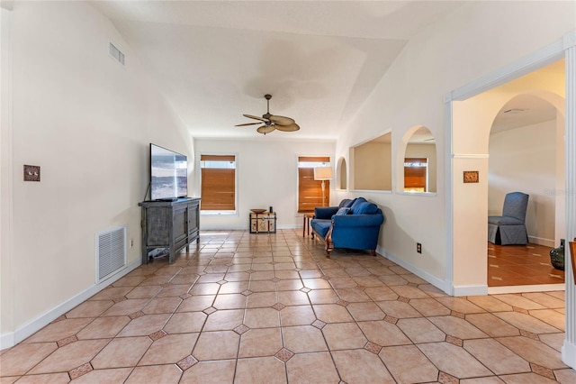 sitting room featuring arched walkways, visible vents, ceiling fan, and light tile patterned floors