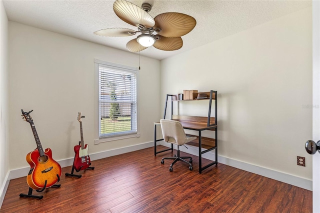 office area with ceiling fan, a textured ceiling, baseboards, and wood finished floors