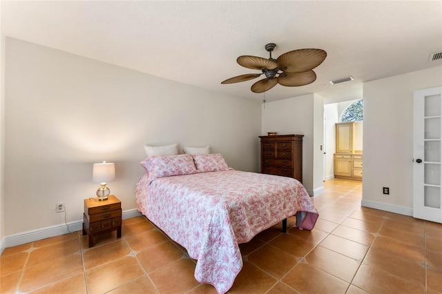 bedroom featuring light tile patterned floors, baseboards, visible vents, and ceiling fan