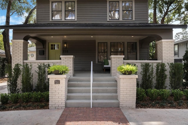 american foursquare style home featuring a porch