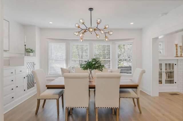 dining area with plenty of natural light, baseboards, light wood-style flooring, and recessed lighting