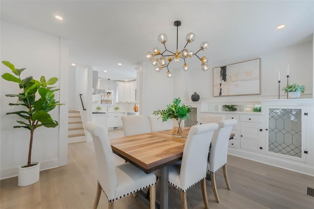 dining space featuring light wood-type flooring, stairway, and recessed lighting