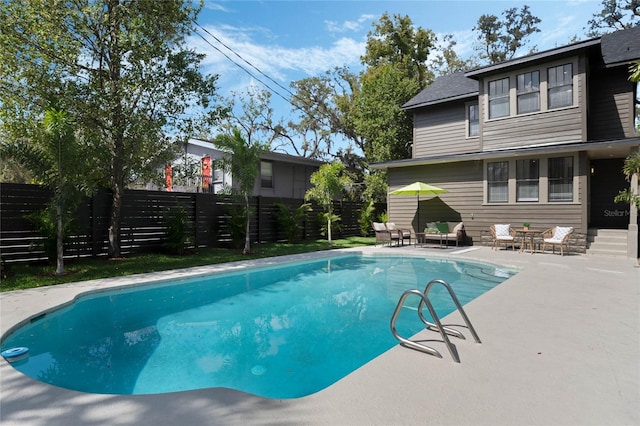 view of pool with a fenced in pool, a patio, and fence