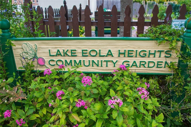 community sign featuring fence