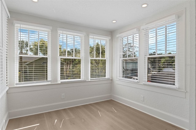 unfurnished sunroom with plenty of natural light