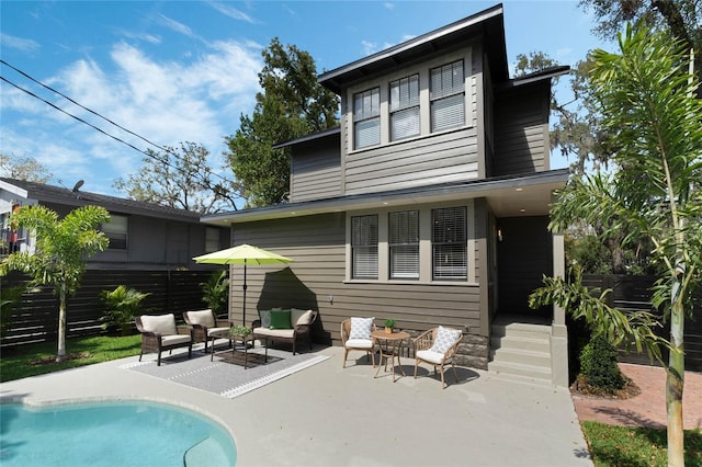 back of house featuring a patio area, an outdoor pool, and an outdoor hangout area