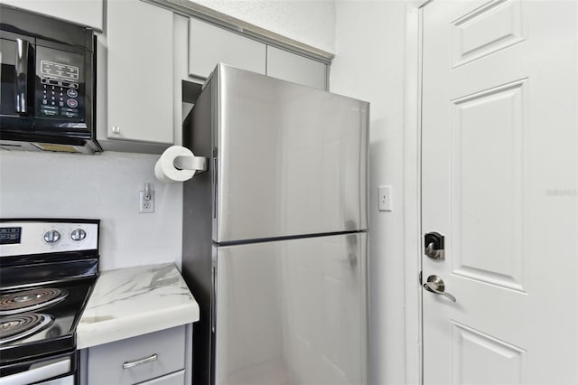 kitchen with appliances with stainless steel finishes and gray cabinetry