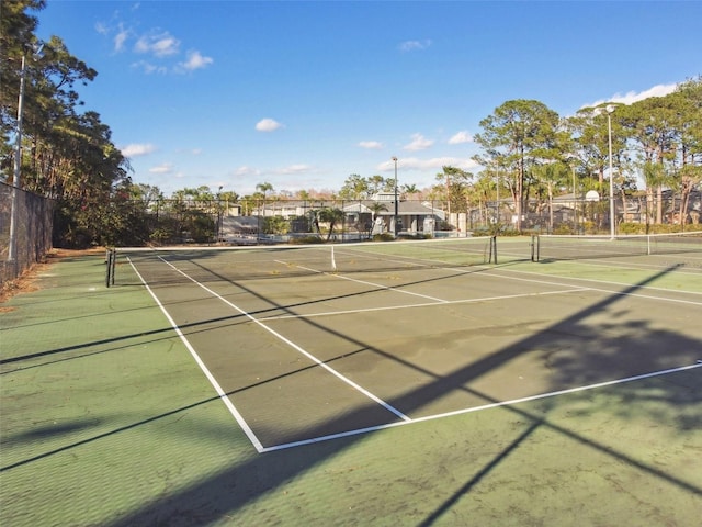 view of tennis court with fence