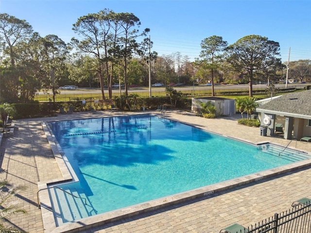 pool featuring a patio area and fence