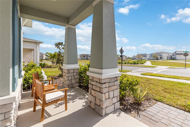 view of patio featuring a residential view and a porch