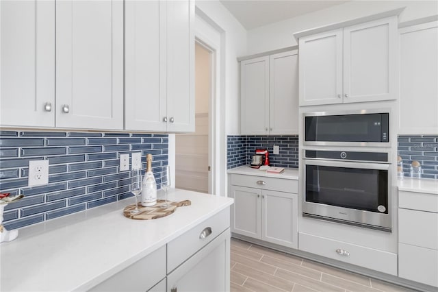 kitchen with backsplash, appliances with stainless steel finishes, and light countertops