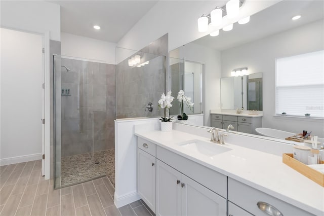 full bathroom with recessed lighting, wood tiled floor, vanity, and a tile shower