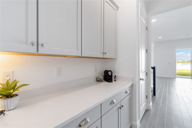 kitchen with recessed lighting, light countertops, and baseboards