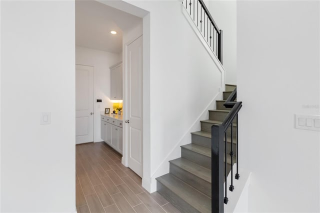 stairway featuring recessed lighting and wood finish floors