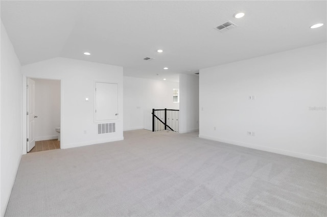 empty room with visible vents, recessed lighting, and light colored carpet