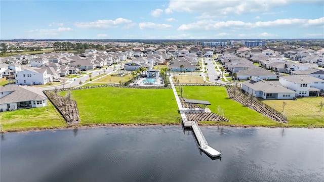 drone / aerial view featuring a residential view and a water view