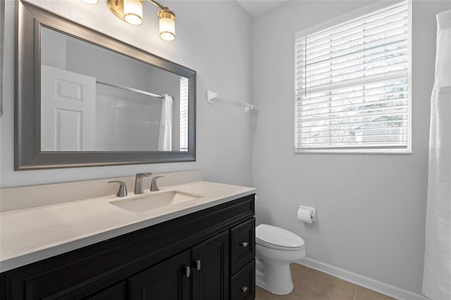 bathroom with curtained shower, toilet, vanity, baseboards, and tile patterned floors