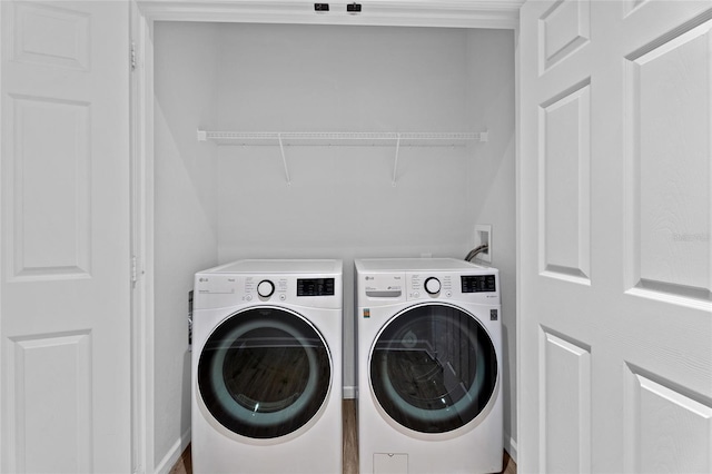 washroom featuring laundry area and washing machine and clothes dryer