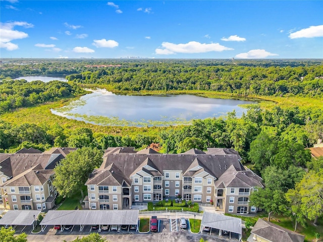 drone / aerial view with a water view and a wooded view