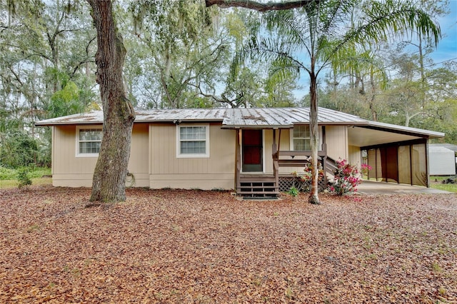 view of front of house with metal roof and an attached carport