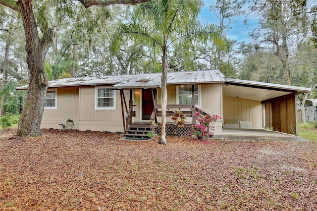 view of front of property featuring covered porch and a carport