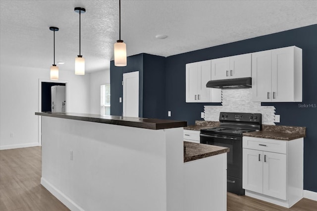 kitchen featuring black / electric stove, dark countertops, decorative light fixtures, and white cabinets