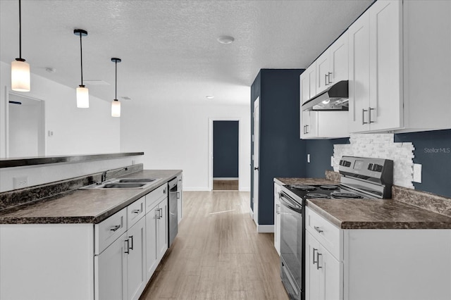 kitchen featuring under cabinet range hood, white cabinets, hanging light fixtures, appliances with stainless steel finishes, and dark countertops