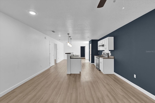 kitchen with white cabinetry, light wood-type flooring, dark countertops, stainless steel range with electric stovetop, and pendant lighting