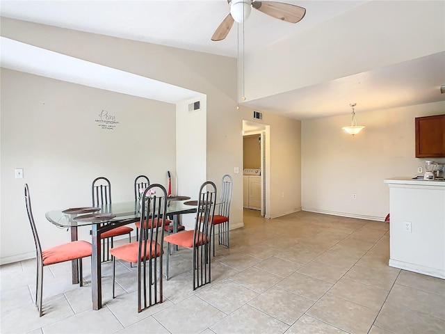 dining space with lofted ceiling, light tile patterned floors, visible vents, and a ceiling fan