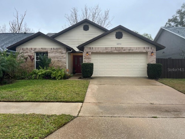 single story home with concrete driveway, brick siding, an attached garage, and a front yard