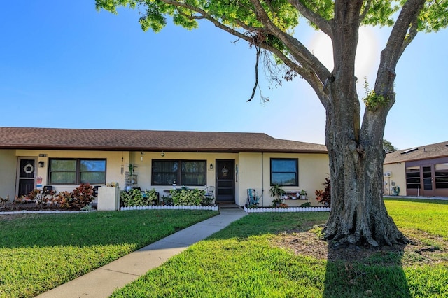 single story home with a front lawn and stucco siding