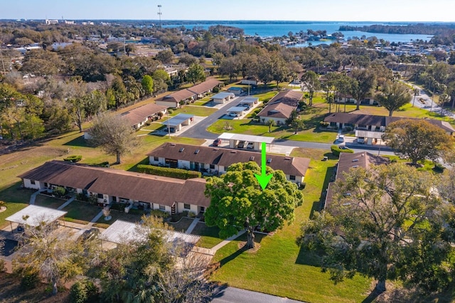 birds eye view of property with a water view and a residential view