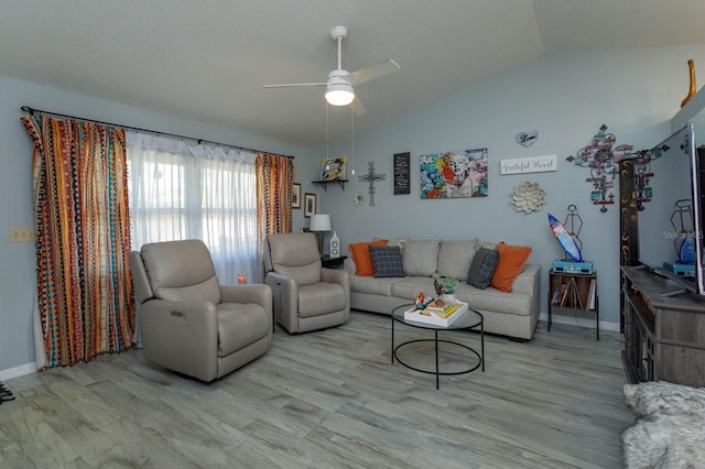 living room with lofted ceiling, light wood finished floors, baseboards, and a ceiling fan