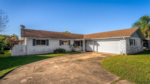 ranch-style home with driveway, stone siding, an attached garage, and a front lawn