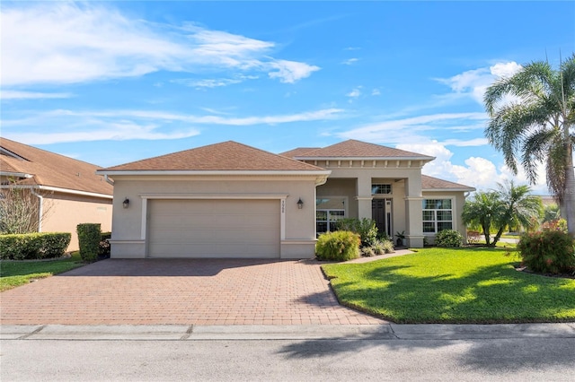 view of front of house featuring a front yard, decorative driveway, an attached garage, and stucco siding