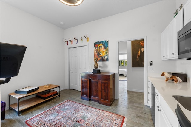 interior space with baseboards and light wood-style floors