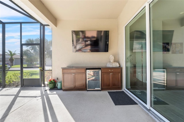 exterior space with wine cooler, floor to ceiling windows, and light colored carpet