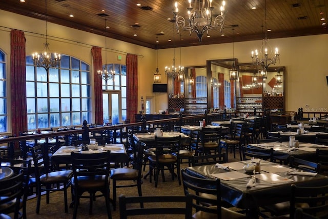 dining room featuring crown molding, wooden ceiling, a notable chandelier, and french doors