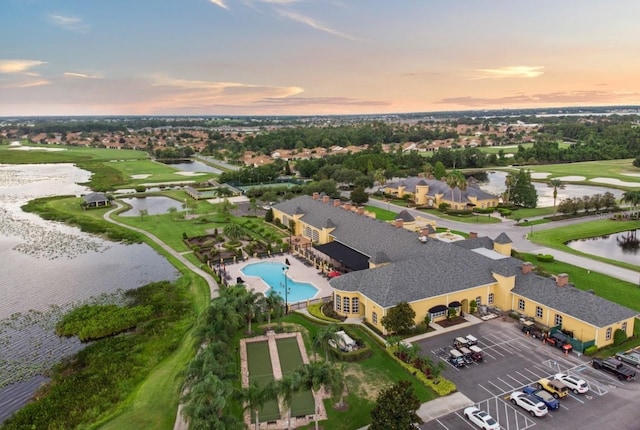 bird's eye view with a water view and golf course view