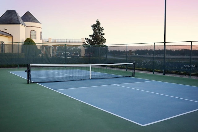 view of tennis court with fence