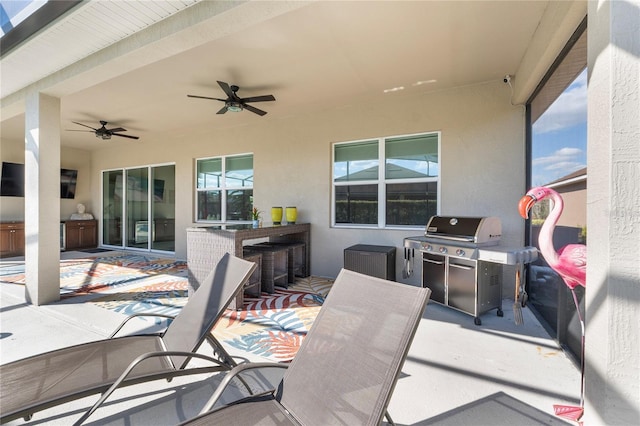 view of patio featuring exterior kitchen, ceiling fan, and area for grilling