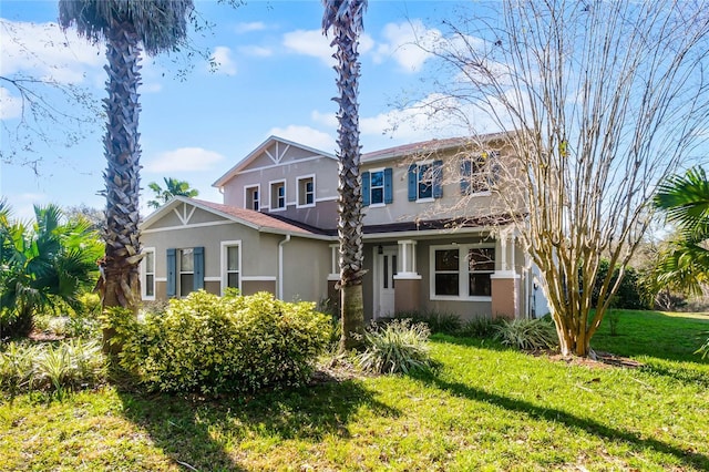 craftsman house with a front lawn and stucco siding