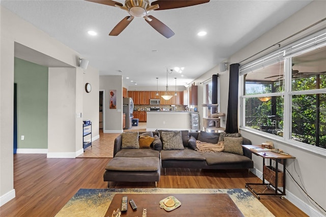 living room with ceiling fan, recessed lighting, wood finished floors, and baseboards