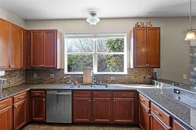 kitchen with hanging light fixtures, decorative backsplash, stainless steel dishwasher, a sink, and dark stone counters