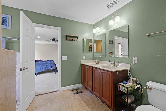 ensuite bathroom featuring toilet, visible vents, a sink, and ensuite bathroom