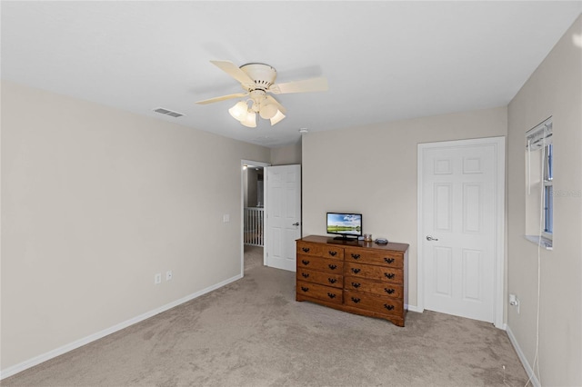 unfurnished bedroom featuring a ceiling fan, carpet, visible vents, and baseboards