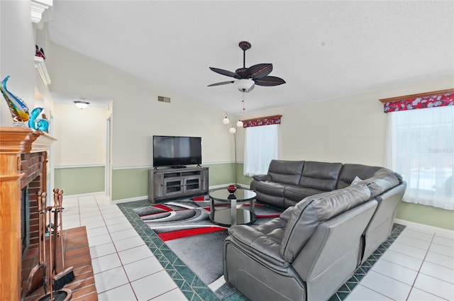 living area with lofted ceiling, plenty of natural light, tile patterned flooring, and visible vents