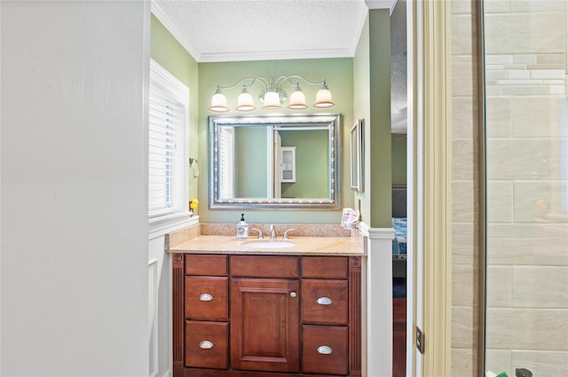 bathroom featuring a textured ceiling, tiled shower, vanity, and crown molding